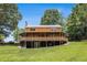 Lovely home with a metal roof, covered patio, and lush lawn at 1795 Hutcheson Ferry Rd, Whitesburg, GA 30185