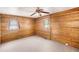 Cozy bedroom features wood paneling and a ceiling fan at 1795 Hutcheson Ferry Rd, Whitesburg, GA 30185