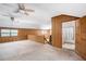 Large upstairs bedroom with wood paneling leading to bathroom at 1795 Hutcheson Ferry Rd, Whitesburg, GA 30185