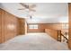 Spacious upstairs bedroom with wood paneling and natural light at 1795 Hutcheson Ferry Rd, Whitesburg, GA 30185