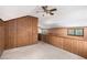 Upper level bonus room with carpet and wood paneling and a small bathroom at 1795 Hutcheson Ferry Rd, Whitesburg, GA 30185
