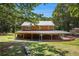 Charming two-story home with a metal roof and expansive covered veranda at 1795 Hutcheson Ferry Rd, Whitesburg, GA 30185