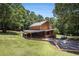 Charming home boasts a metal roof and covered veranda, nestled in a lush landscape at 1795 Hutcheson Ferry Rd, Whitesburg, GA 30185