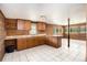 Well-lit kitchen features ample cabinet space, tile floors and breakfast bar at 1795 Hutcheson Ferry Rd, Whitesburg, GA 30185
