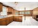 Bright kitchen featuring wood cabinets, tile floors, and breakfast bar at 1795 Hutcheson Ferry Rd, Whitesburg, GA 30185