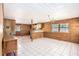 Open concept living room with tile flooring, wood paneling, and natural light at 1795 Hutcheson Ferry Rd, Whitesburg, GA 30185