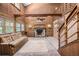 Cozy living area featuring a stone fireplace, wooden walls, and staircase at 1795 Hutcheson Ferry Rd, Whitesburg, GA 30185