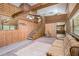 Spacious living area with wooden accents, high ceilings, and staircase to loft at 1795 Hutcheson Ferry Rd, Whitesburg, GA 30185