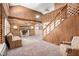 Inviting living room features wood paneling, fireplace, and staircase at 1795 Hutcheson Ferry Rd, Whitesburg, GA 30185