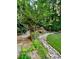 Lush backyard featuring a stone pathway, vibrant greenery, and beautiful landscaping for a serene outdoor retreat at 2672 Brickell Square, Atlanta, GA 30341