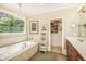 Luxury bathroom with a soaking tub, chandelier, double sinks, and a walk-in closet at 2672 Brickell Square, Atlanta, GA 30341