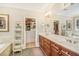 Bathroom featuring double sinks, a large mirror, and access to a walk-in closet at 2672 Brickell Square, Atlanta, GA 30341
