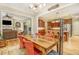 Open dining room with hardwood floors, a wooden table with red chairs, and views into the living room and kitchen at 2672 Brickell Square, Atlanta, GA 30341