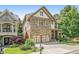 Beautiful stone-front home with attached two-car garage and well-manicured lawn at 2672 Brickell Square, Atlanta, GA 30341