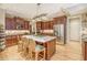 Spacious kitchen with a granite island, wooden cabinets, stainless steel appliances, and hardwood floors at 2672 Brickell Square, Atlanta, GA 30341