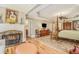 Main bedroom featuring a fireplace, four-poster bed, hardwood floors, and access to a bathroom at 2672 Brickell Square, Atlanta, GA 30341