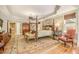 Serene main bedroom with a four-poster bed, hardwood floors, sitting area, and plenty of natural light at 2672 Brickell Square, Atlanta, GA 30341