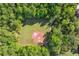 An aerial view of a baseball field surrounded by lush trees in a residential neighborhood at 3220 Goldmist Dr, Buford, GA 30519
