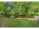 Large backyard with a storage shed and lush trees providing privacy at 3220 Goldmist Dr, Buford, GA 30519