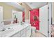 Bright bathroom with double vanity, modern fixtures and colorful JoJo Siwa shower curtain at 3220 Goldmist Dr, Buford, GA 30519