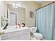 A full bath shows a vanity and toilet with a light blue shower curtain at 3220 Goldmist Dr, Buford, GA 30519