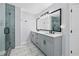 Stylishly updated bathroom featuring a dual sink vanity, marble floors and glass shower at 3220 Goldmist Dr, Buford, GA 30519