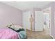 Cozy bedroom with neutral carpet and white door for closet or ensuite access at 3220 Goldmist Dr, Buford, GA 30519