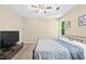 An ample bedroom features neutral walls, a ceiling fan, and a queen sized bed at 3220 Goldmist Dr, Buford, GA 30519