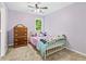 A bedroom showcases a white iron bed frame and a lovely view at 3220 Goldmist Dr, Buford, GA 30519