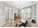 Bright dining room featuring a large wooden table set, neutral paint, and a traditional chandelier at 3220 Goldmist Dr, Buford, GA 30519