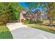 Two-story home showcasing a long driveway, well-maintained landscaping, and charming curb appeal at 3220 Goldmist Dr, Buford, GA 30519