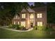 Charming two-story brick home featuring a well-manicured lawn and mature landscaping at 3220 Goldmist Dr, Buford, GA 30519