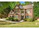 Inviting two-story home with a manicured lawn and lush landscaping; a beautiful place to call home at 3220 Goldmist Dr, Buford, GA 30519