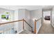 Upstairs hallway with wood banister and carpet, leading to bedrooms at 3220 Goldmist Dr, Buford, GA 30519