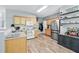 Traditional kitchen featuring stainless steel appliances, light wood cabinets, and wood-look flooring at 3220 Goldmist Dr, Buford, GA 30519