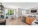A brightly lit kitchen, features wood look floors and a breakfast nook, and access to the living room at 3220 Goldmist Dr, Buford, GA 30519