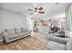 Spacious living room with gray couches, new wood-look floors, and open access to the kitchen at 3220 Goldmist Dr, Buford, GA 30519