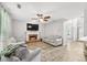 Inviting living room with a fireplace, gray couches, a ceiling fan and new wood-look floors at 3220 Goldmist Dr, Buford, GA 30519