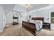 Spacious main bedroom with tray ceiling and treadmill located near a sunlit window at 3220 Goldmist Dr, Buford, GA 30519