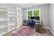 Well-lit office featuring a large window, plush rug and ample shelving for storage at 3220 Goldmist Dr, Buford, GA 30519