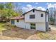 Backyard featuring a house with white siding, walkout basement, and patio at 6684 Heathrow Ln, Stone Mountain, GA 30087