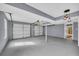 Spacious two car garage with windows and overhead lighting fixtures at 6684 Heathrow Ln, Stone Mountain, GA 30087