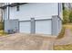 Two car garage beneath a home's brick and vinyl exterior at 6684 Heathrow Ln, Stone Mountain, GA 30087