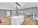 Open-concept kitchen and living area with a kitchen island with bar stool seating at 6684 Heathrow Ln, Stone Mountain, GA 30087