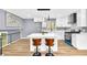 Modern kitchen boasts stainless steel appliances, white cabinets, and a breakfast bar at 6684 Heathrow Ln, Stone Mountain, GA 30087