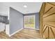 Cozy room with hardwood floors, double doors and artistic wood accent wall at 6684 Heathrow Ln, Stone Mountain, GA 30087