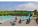 Community pool with water slides, lounge chairs, umbrellas, and tables at 1005 Woodbury Rd, Canton, GA 30114