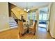 Inviting dining area with wood floors and staircase, next to a screen porch at 1005 Woodbury Rd, Canton, GA 30114