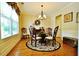 Formal dining room with hardwood flooring, elegant decor and plenty of natural light at 1005 Woodbury Rd, Canton, GA 30114