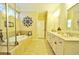 Bright bathroom with a soaking tub and a vanity with double sinks and white cabinets at 1005 Woodbury Rd, Canton, GA 30114
